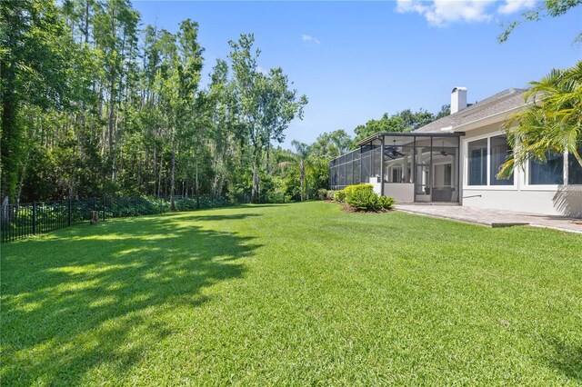 4512 Cheval Blvd, Lutz, FL 33558 - view of yard featuring a sunroom and a ceiling fan