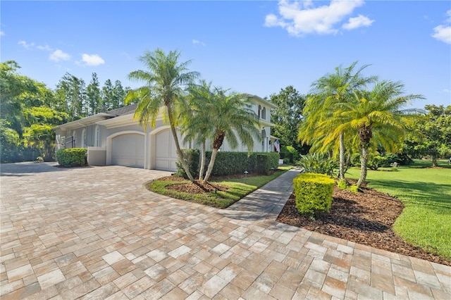4512 Cheval Blvd, Lutz, FL 33558 - view of front facade with an attached garage, driveway, a front lawn, and stucco siding