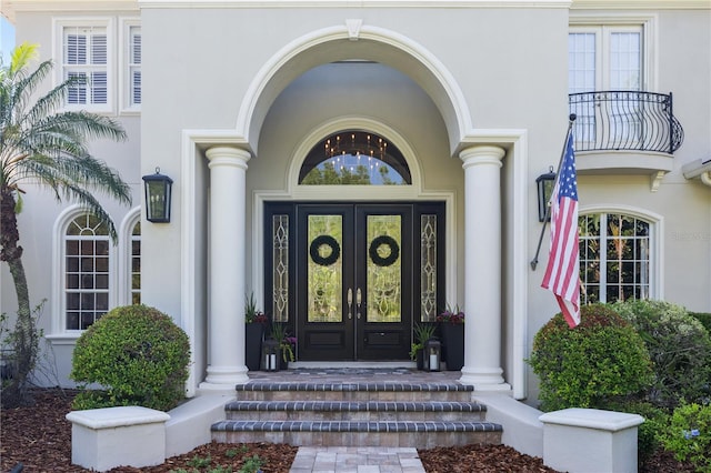 4512 Cheval Blvd, Lutz, FL 33558 - view of exterior entry with french doors, a balcony, stucco siding, and a porch