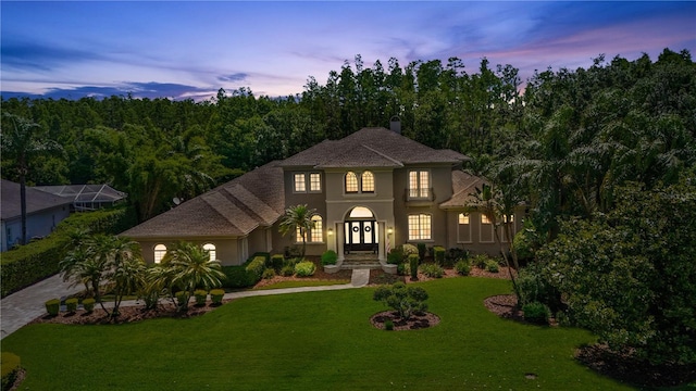 4512 Cheval Blvd, Lutz, FL 33558 - view of front of house with stucco siding, a yard, and driveway