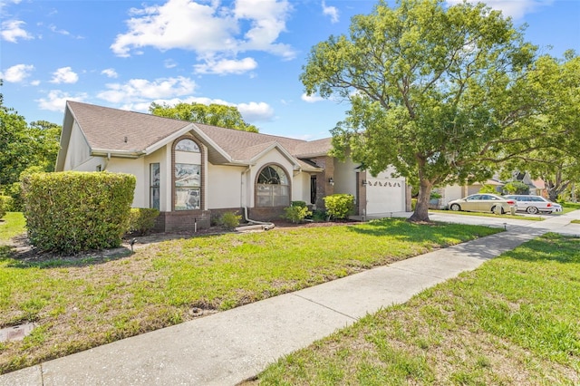 5434 Wellfield Rd, New Port Richey, FL 34655 - view of front facade with driveway, stucco siding, an attached garage, and a front lawn