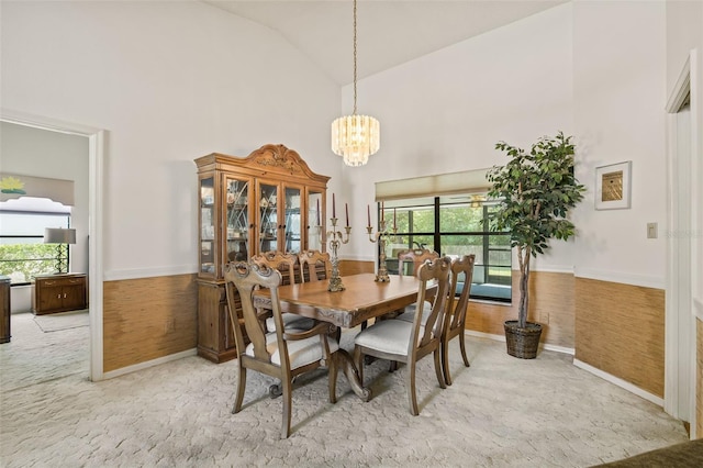 5434 Wellfield Rd, New Port Richey, FL 34655 - dining space featuring high vaulted ceiling, a chandelier, baseboards, and carpet