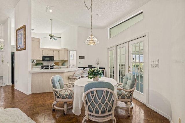 5434 Wellfield Rd, New Port Richey, FL 34655 - dining room featuring a textured ceiling, baseboards, high vaulted ceiling, and a ceiling fan