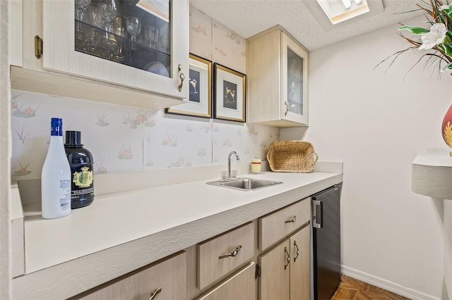 5434 Wellfield Rd, New Port Richey, FL 34655 - kitchen with a sink, light countertops, light brown cabinets, glass insert cabinets, and a textured ceiling