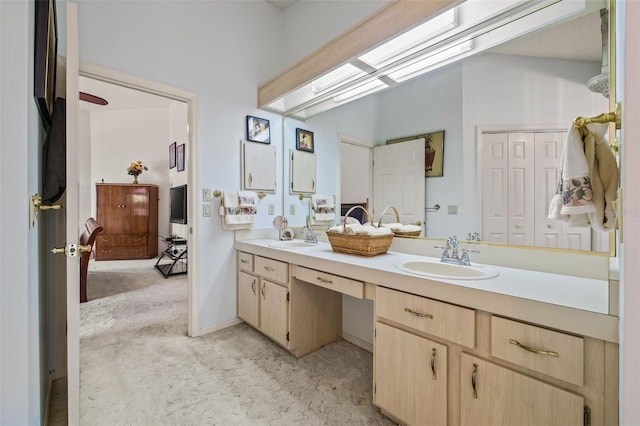 5434 Wellfield Rd, New Port Richey, FL 34655 - bathroom featuring double vanity and a skylight