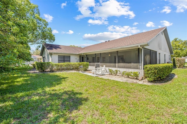 5434 Wellfield Rd, New Port Richey, FL 34655 - rear view of property featuring a sunroom, a lawn, and stucco siding