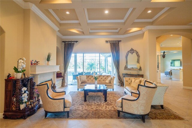 15101 Kestrelglen Way, Lithia, FL 33547 - tiled living area featuring ornamental molding, arched walkways, coffered ceiling, a ceiling fan, and beamed ceiling