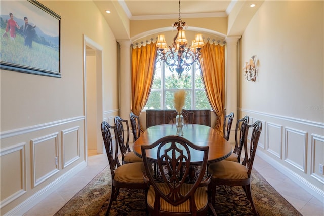 15101 Kestrelglen Way, Lithia, FL 33547 - dining area featuring a chandelier, a decorative wall, ornamental molding, a wainscoted wall, and ornate columns