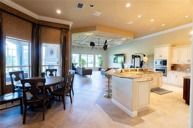 15101 Kestrelglen Way, Lithia, FL 33547 - kitchen featuring stainless steel appliances, crown molding, a sink, a spacious island, and coffered ceiling
