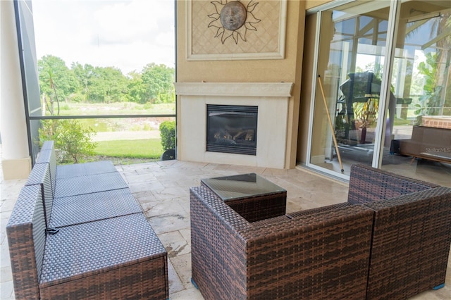 15101 Kestrelglen Way, Lithia, FL 33547 - living area with stone tile flooring and a glass covered fireplace