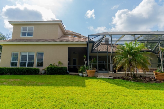 15101 Kestrelglen Way, Lithia, FL 33547 - back of property with stucco siding, a yard, a tiled roof, and a lanai