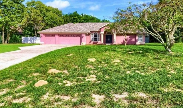 14273 Nugent Cir, Spring Hill, FL 34609 - ranch-style home with a garage, concrete driveway, and stucco siding
