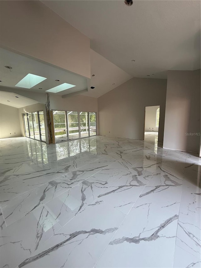 14273 Nugent Cir, Spring Hill, FL 34609 - unfurnished room featuring a skylight, lofted ceiling, and light marble finish floors