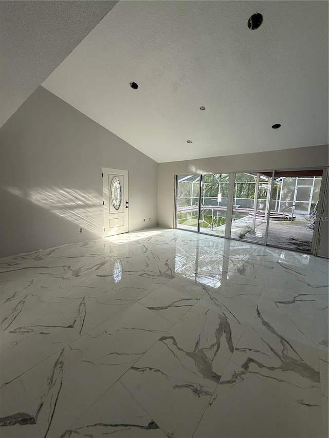 14273 Nugent Cir, Spring Hill, FL 34609 - empty room featuring marble finish floors, a textured ceiling, recessed lighting, and lofted ceiling