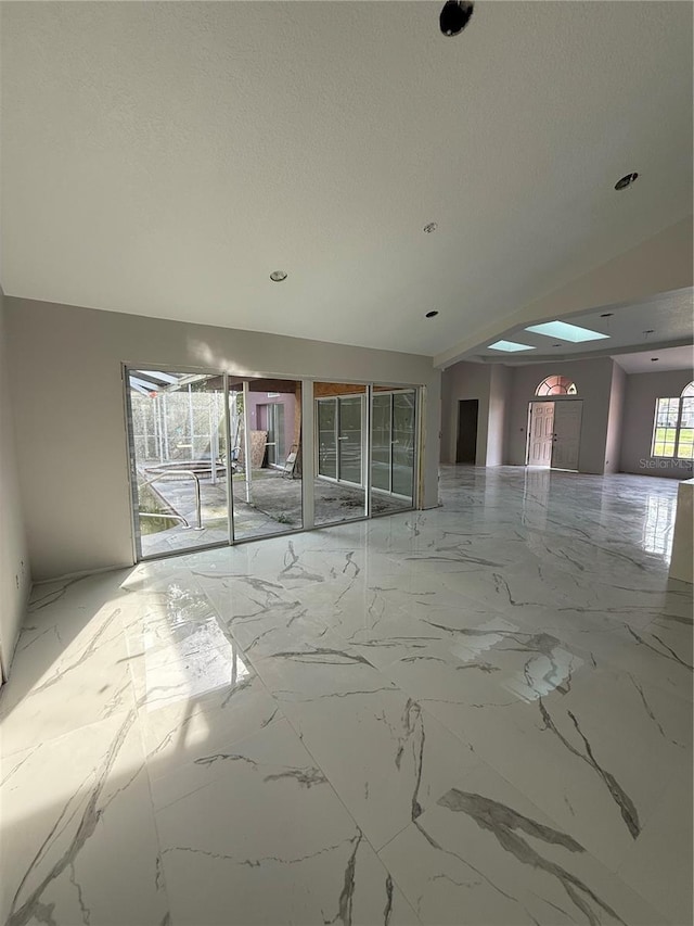 14273 Nugent Cir, Spring Hill, FL 34609 - unfurnished room with marble tiled flooring, a textured ceiling, and recessed lighting