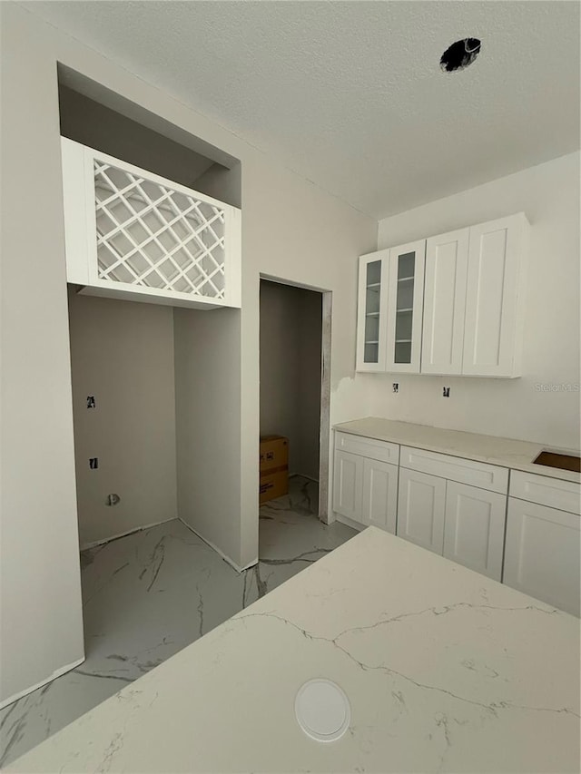 14273 Nugent Cir, Spring Hill, FL 34609 - unfurnished bedroom featuring light marble finish floors and a textured ceiling