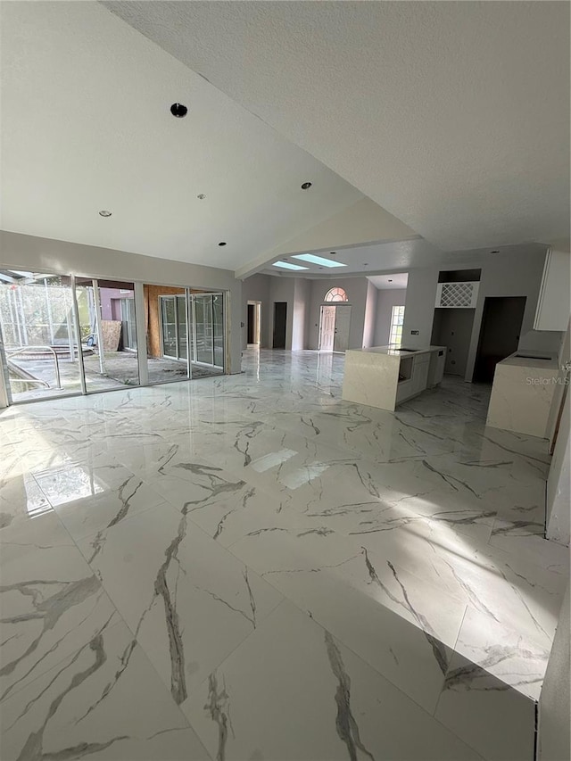 14273 Nugent Cir, Spring Hill, FL 34609 - unfurnished room featuring light marble finish flooring, vaulted ceiling, and recessed lighting