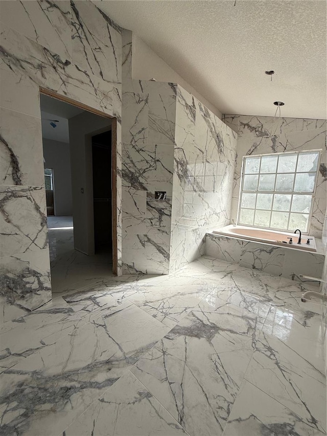 14273 Nugent Cir, Spring Hill, FL 34609 - full bath featuring stone wall, a garden tub, and a textured ceiling