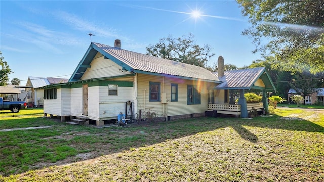 138 S Hernando Ave, Arcadia, FL 34266 - view of front of house with a chimney, metal roof, and a front lawn