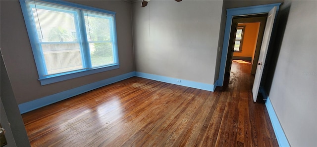 138 S Hernando Ave, Arcadia, FL 34266 - empty room with plenty of natural light, wood finished floors, and ceiling fan