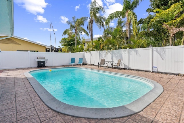 1818 Indian Rocks Rd S, Largo, FL 33774 - view of swimming pool featuring a fenced backyard, a grill, and a patio area