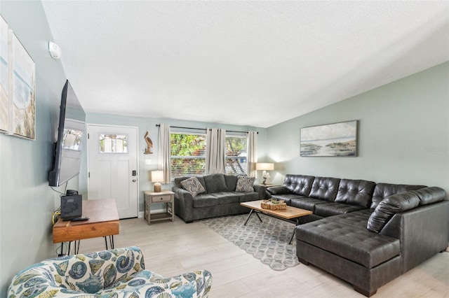 1818 Indian Rocks Rd S, Largo, FL 33774 - living area featuring light wood-type flooring, vaulted ceiling, and a textured ceiling
