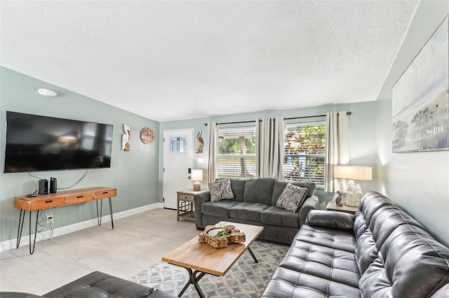 1818 Indian Rocks Rd S, Largo, FL 33774 - living room featuring a textured ceiling, light wood-style flooring, and baseboards
