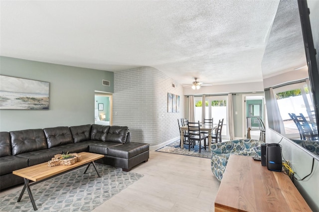 1818 Indian Rocks Rd S, Largo, FL 33774 - living room featuring a ceiling fan and a textured ceiling