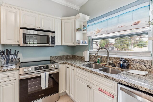 1818 Indian Rocks Rd S, Largo, FL 33774 - kitchen with appliances with stainless steel finishes, a sink, crown molding, and white cabinets