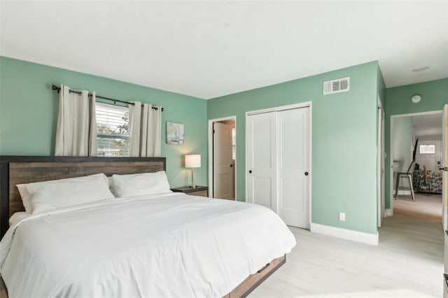 1818 Indian Rocks Rd S, Largo, FL 33774 - bedroom with light wood finished floors, a closet, and baseboards