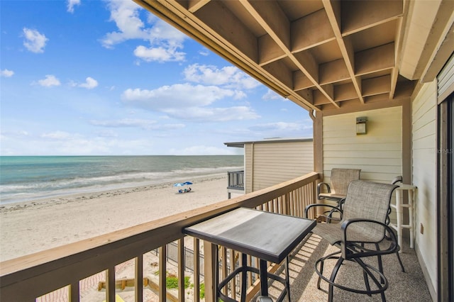 balcony with view of water and beach