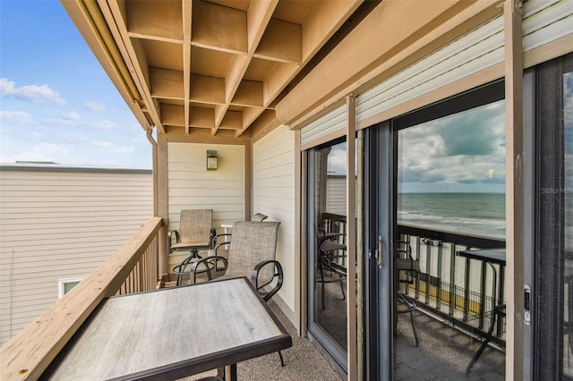 balcony featuring view of water and beach