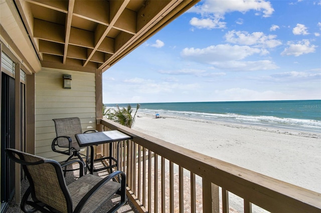 balcony featuring view of water and beach