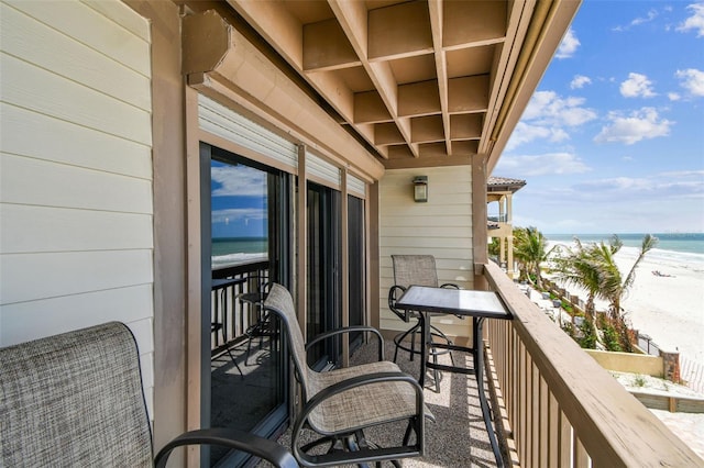 balcony featuring view of water and beach