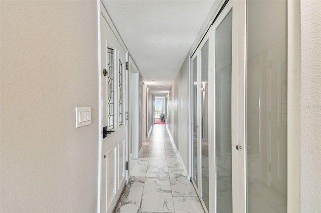 corridor with light marble finish flooring