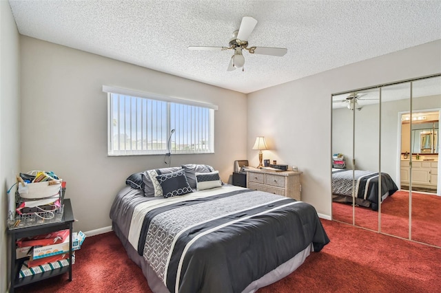 carpeted bedroom with a textured ceiling, a closet, a ceiling fan, and baseboards