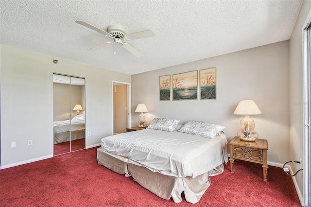 bedroom featuring carpet, a textured ceiling, a closet, baseboards, and a ceiling fan
