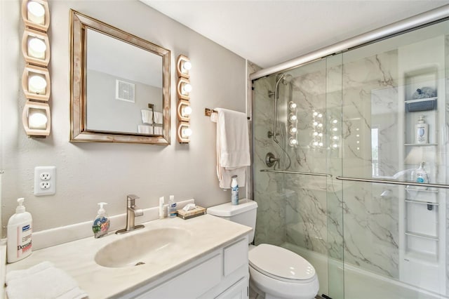 full bath with toilet, a marble finish shower, and vanity