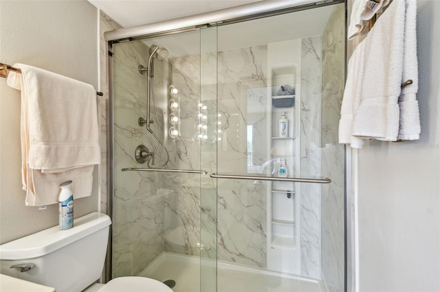 full bath featuring a marble finish shower and toilet