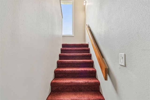 staircase with a textured wall