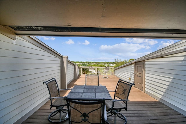 wooden terrace featuring outdoor dining space
