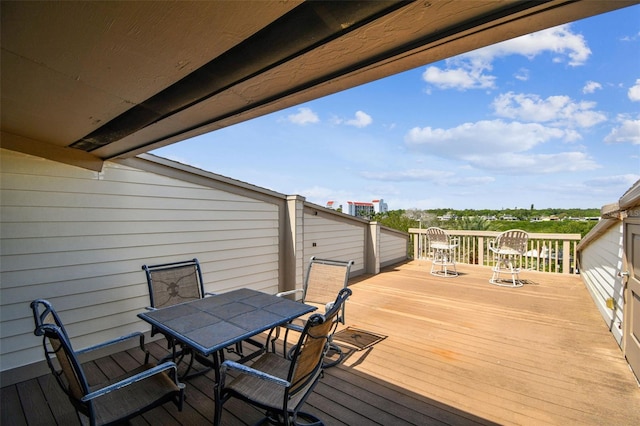 wooden terrace featuring outdoor dining space