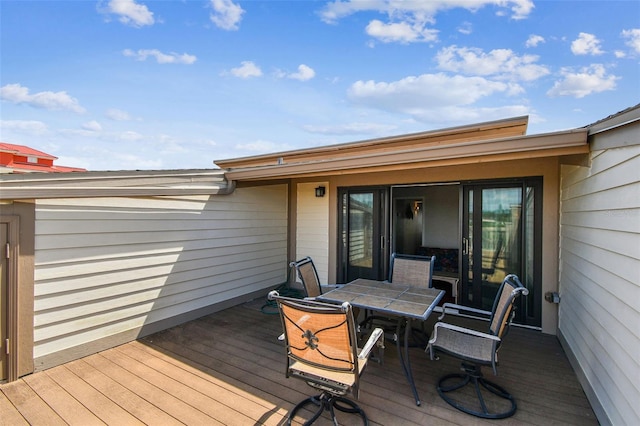 wooden terrace with outdoor dining space