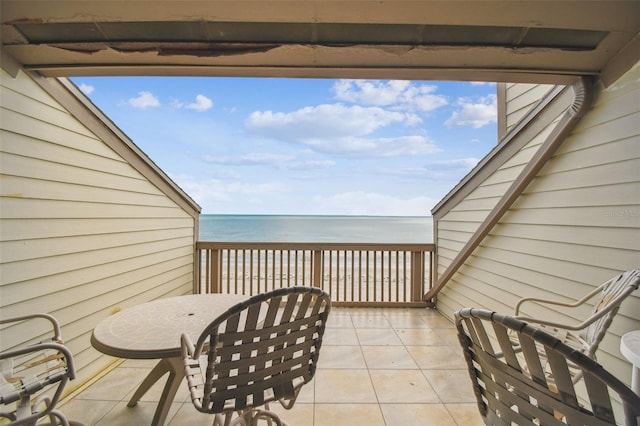 view of patio featuring a water view and a balcony