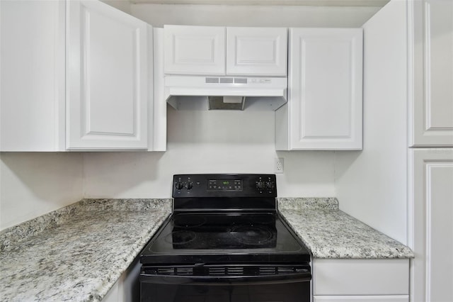 1810 77th Ave N, Saint Petersburg, FL 33702 - kitchen featuring black / electric stove, under cabinet range hood, white cabinetry, and light stone countertops