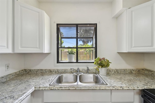 1810 77th Ave N, Saint Petersburg, FL 33702 - kitchen with a sink, light countertops, white cabinetry, and black range with electric cooktop