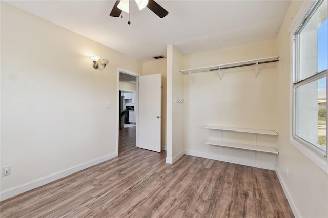 1810 77th Ave N, Saint Petersburg, FL 33702 - unfurnished bedroom with wood finished floors, baseboards, a ceiling fan, and a closet