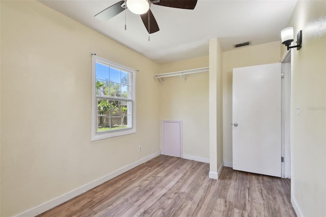 1810 77th Ave N, Saint Petersburg, FL 33702 - unfurnished bedroom featuring wood finished floors, baseboards, a closet, and a ceiling fan