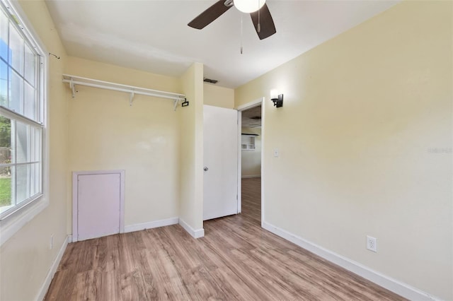 1810 77th Ave N, Saint Petersburg, FL 33702 - unfurnished bedroom featuring wood finished floors, baseboards, a closet, and a ceiling fan