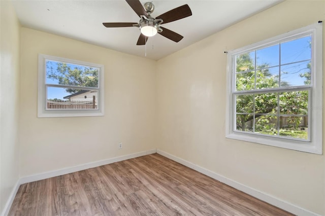 1810 77th Ave N, Saint Petersburg, FL 33702 - empty room featuring baseboards, wood finished floors, and ceiling fan